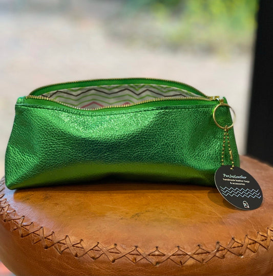 Green metallic leather pouch with a gold zipper with zigzag waterproof lining