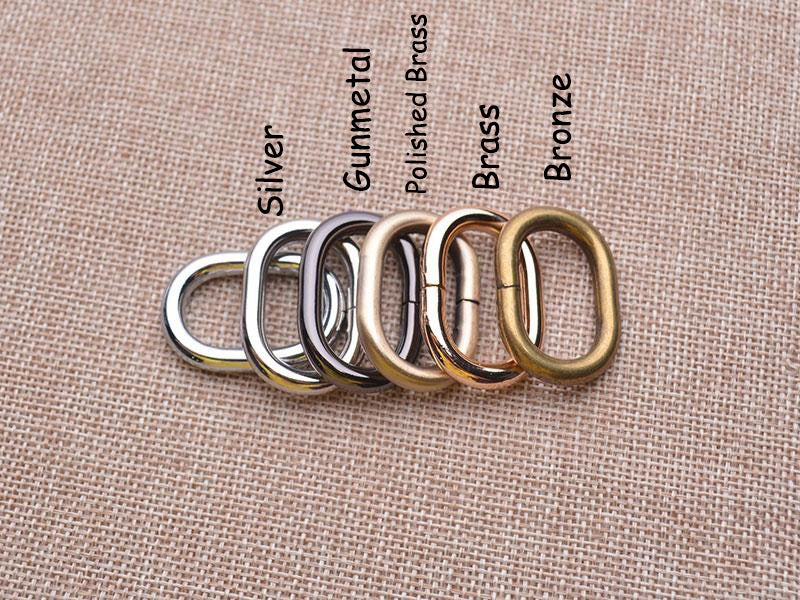 Set of metal rings in various finishes on a textured fabric background