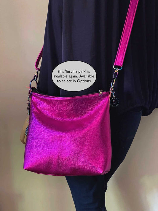 Person wearing a bright pink handbag with text overlay on a plain background
