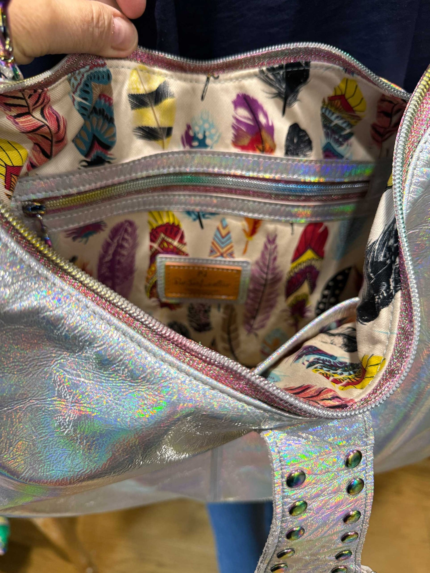 Holographic handbag with colorful interior and inside zipper pocket