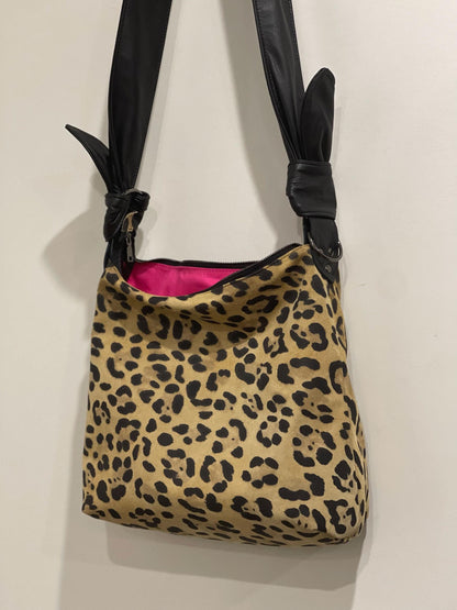 black and tan Leopard print bag with black strap feature