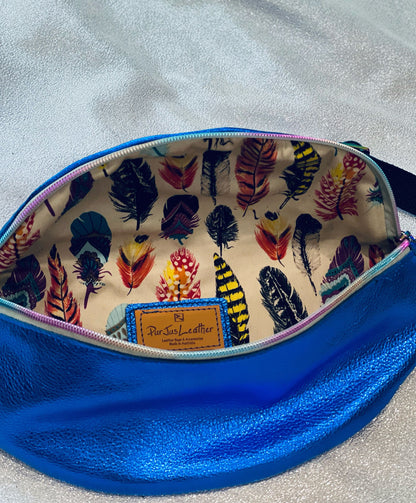 metallic Blue pouch with feather patterned interior lining with rainbow zipper