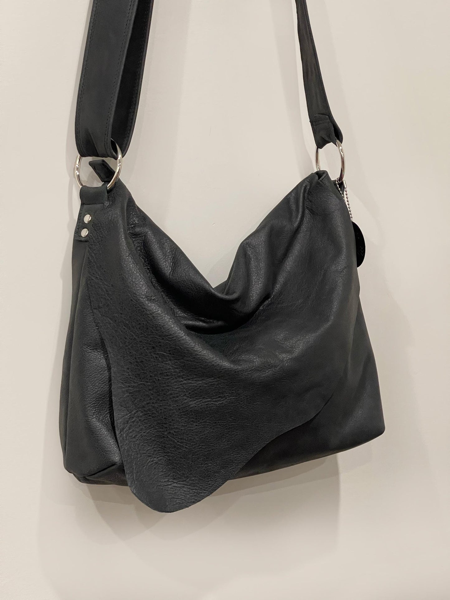 Distressed Black Leather Crossbody Bag with asymmetrical flap