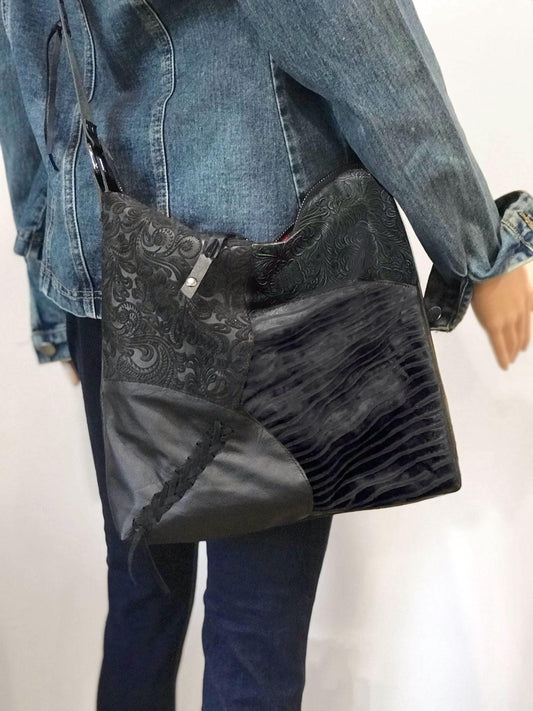 Person wearing a black textured bag over one shoulder 