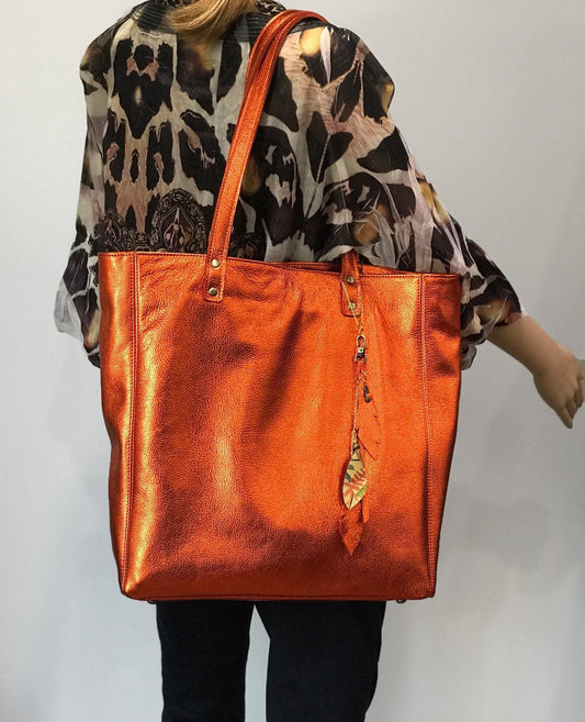 Soft warm metallic orange leather Tote lined. bottom feet and padding. Large size on model