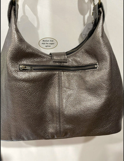 Pewter leather handbag with bronze zipper pocket outside a visible brand label on a white background