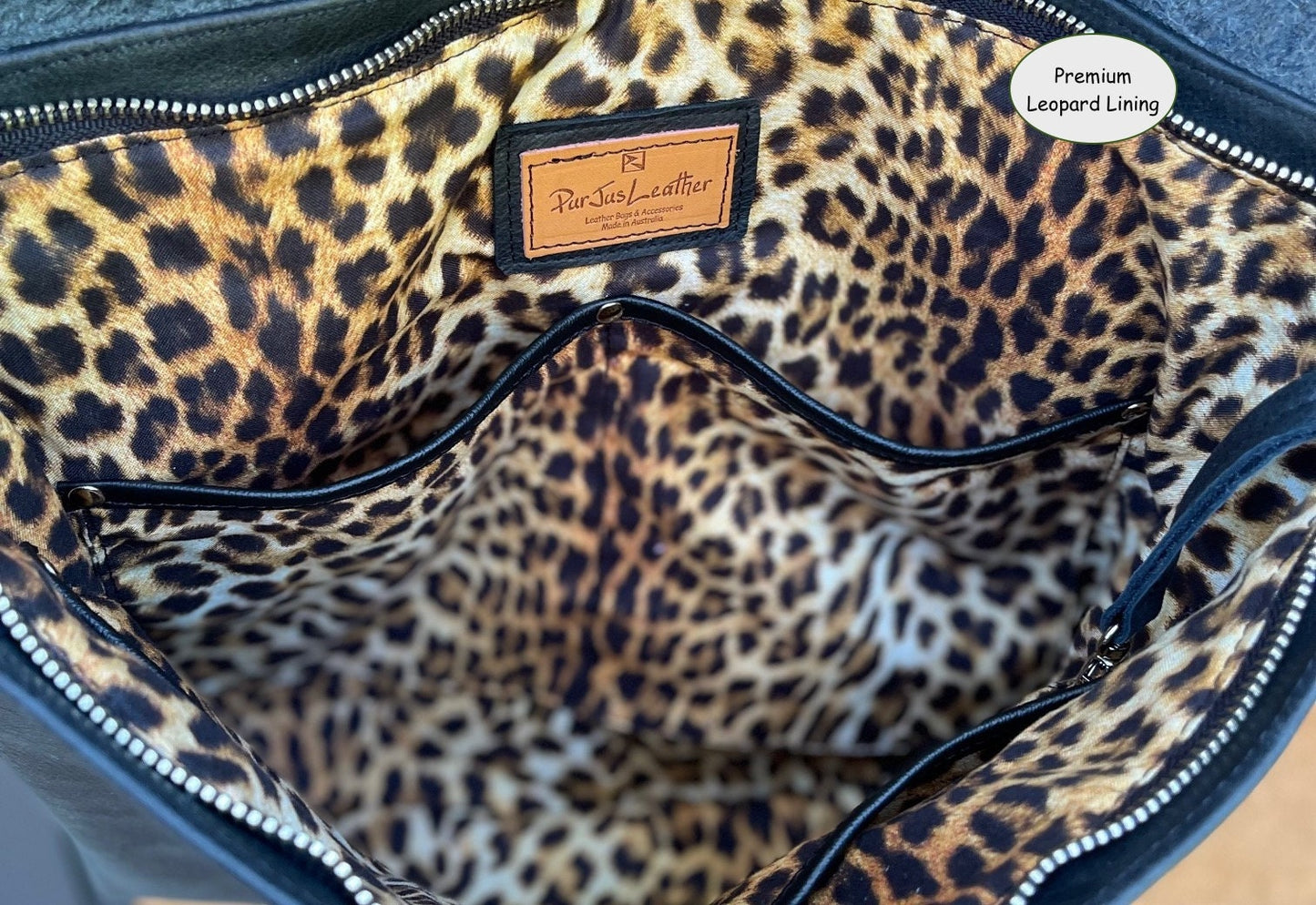 Leopard print lining inside a bag with leather edged slip pockets and rivets and key clasp