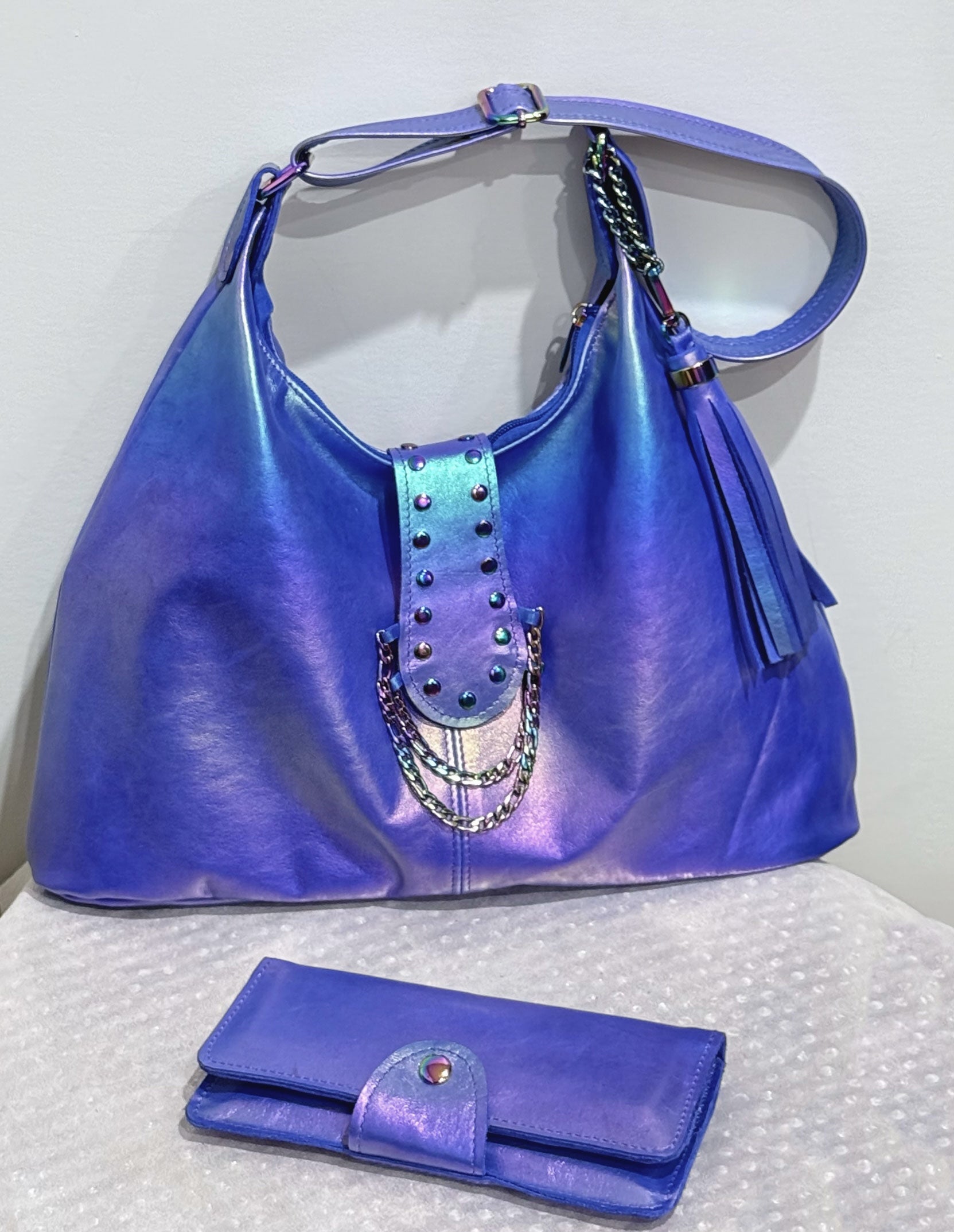 blue handbag with studded detail and matching wallet