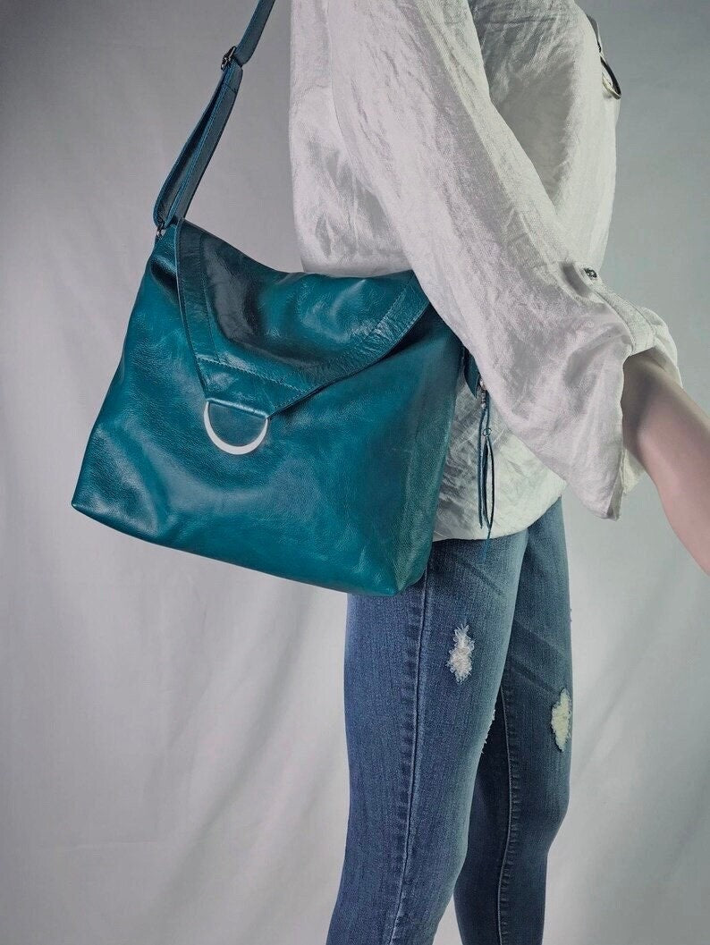 Teal leather bag with front flap and magnet closure