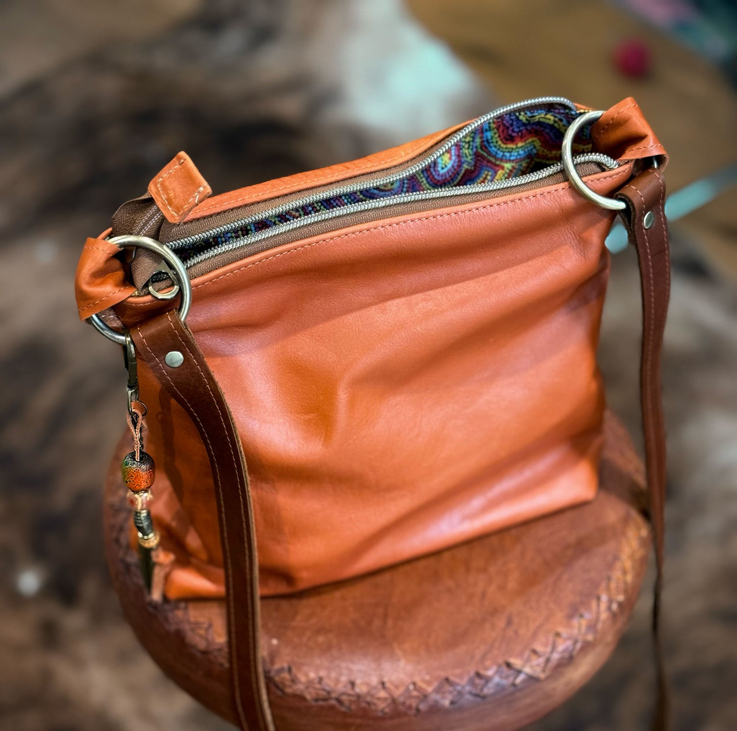 warm tan leather bag with brass O rings and lining