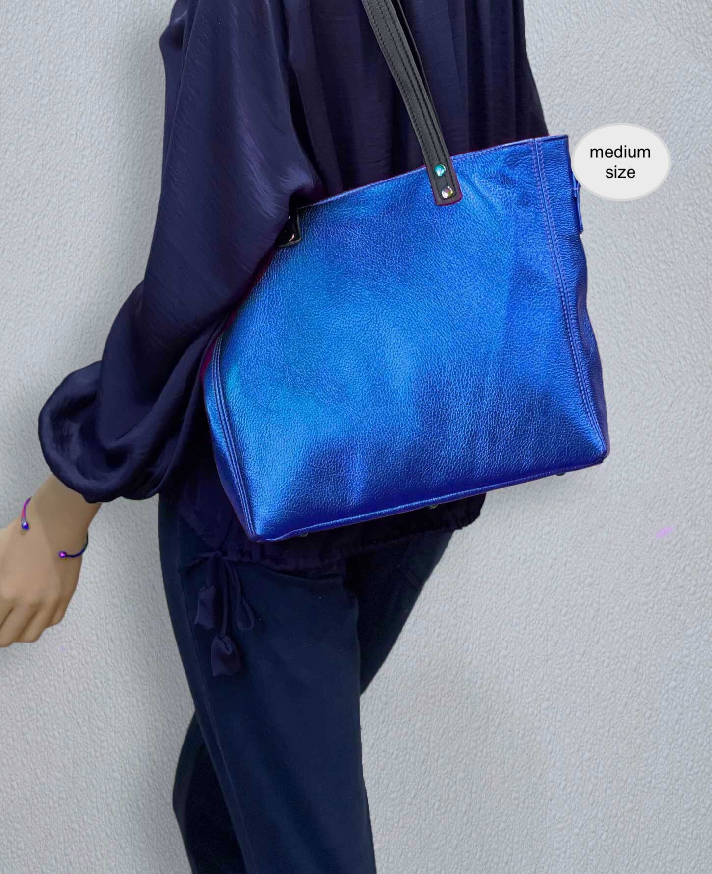 Person wearing a blue bag with a plain background
