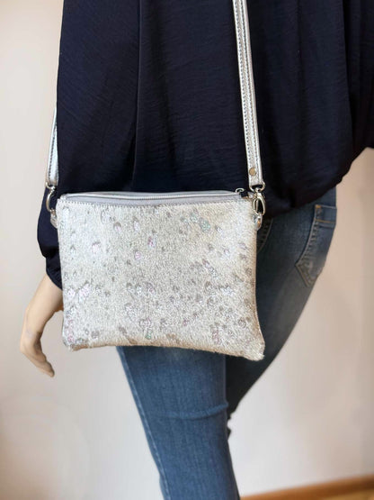 Model wearing Small Acid wash Iridescent holographic cowhide and metallic silver leather bag