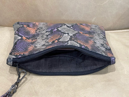 realistic snakeskin embossed patterned pouch with a zipper closure and removable wristlet strap