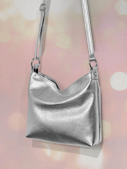 Premium Silver metallic crossbody bag with hidden zipper closure and adjustable strap attached to large O rings