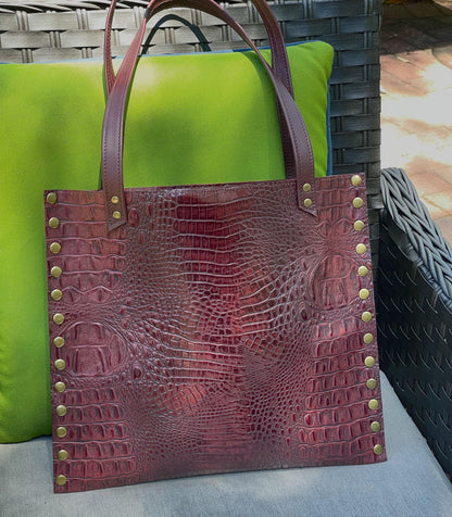 burgundy crocodile textured tote bag with brass studs and strong double handles