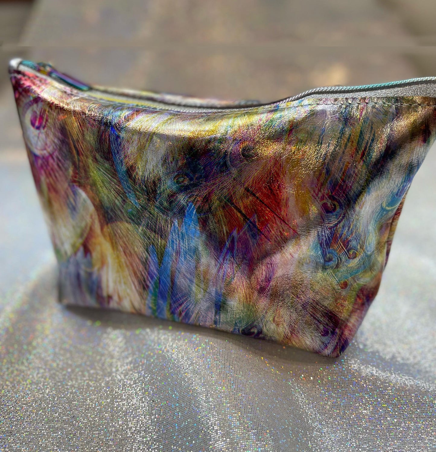 multicoloured feather print metallic leather pouch