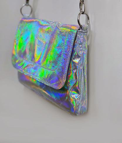 Holographic clutch bag with flap side angle showing the depth of the bag and strap attachment on O rings.