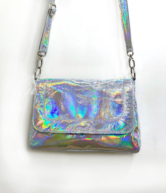 closeup of holographic handbag with silver hardware on a white background