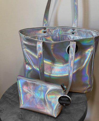 Holographic silver tote with matching pouch on a gray surface