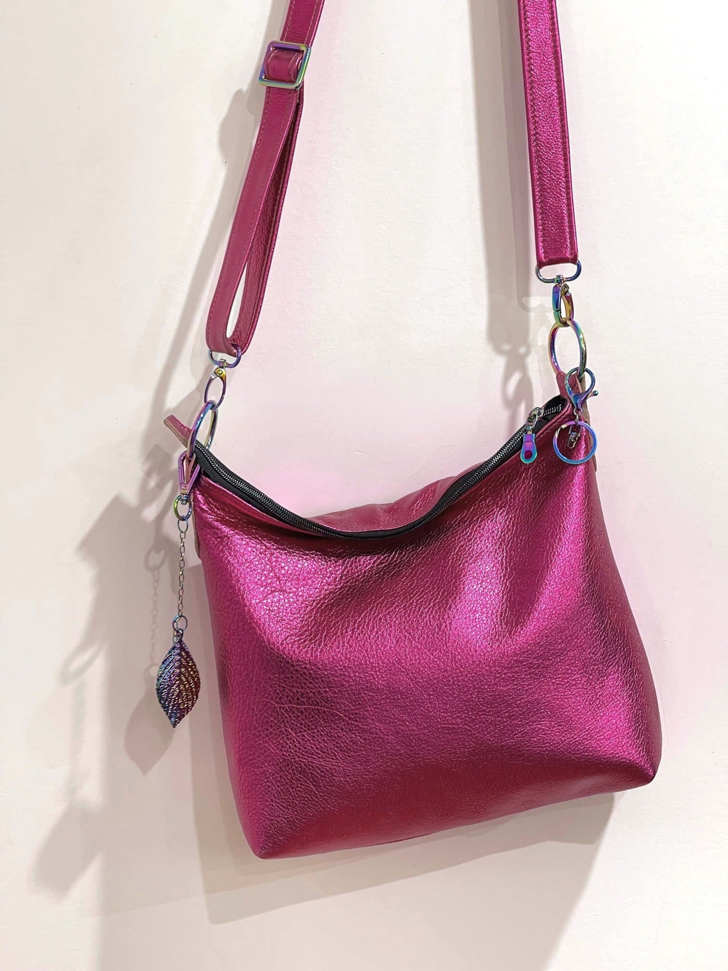 Pink handbag with a strap on a light pink background