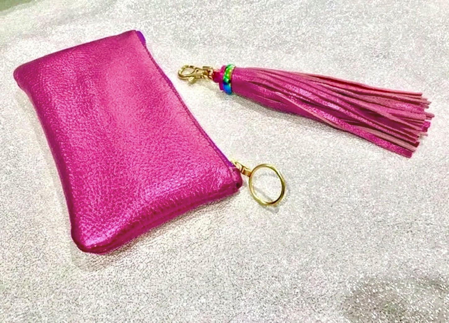 Pink pouch with a tassel on a glittery background