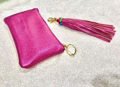 Pink pouch with a tassel on a glittery background