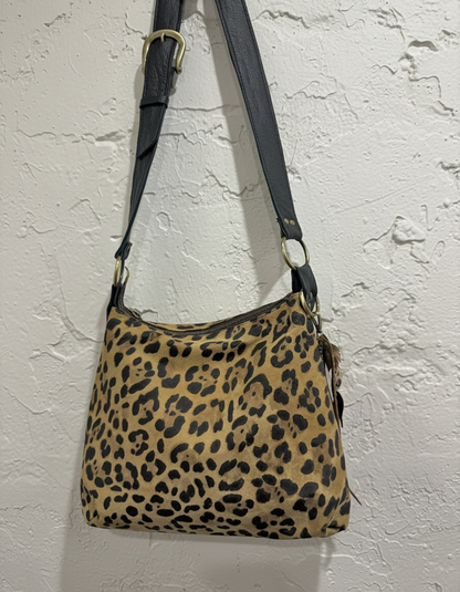 Leopard bag on rustic textured wall