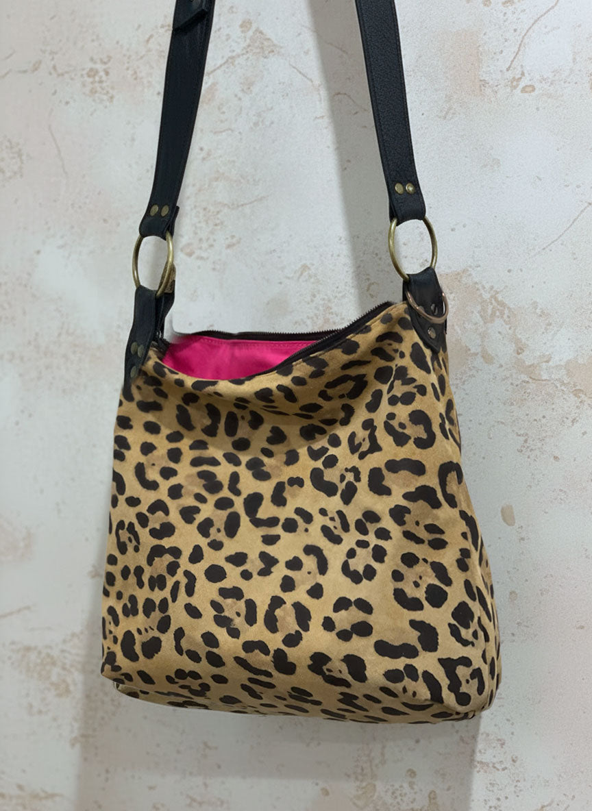 Leopard print handbag with a pink interior and large O ring feature