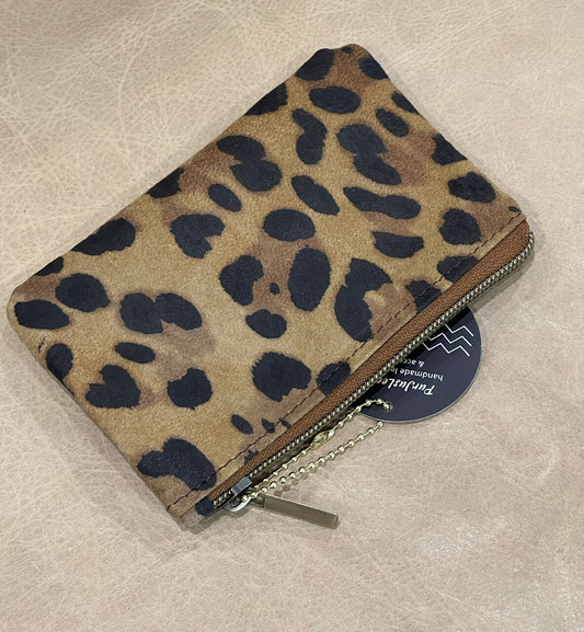 Leopard print wallet on a beige surface