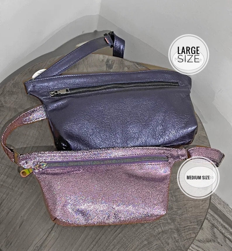 Two fanny packs, one large and one medium, on a gray stall