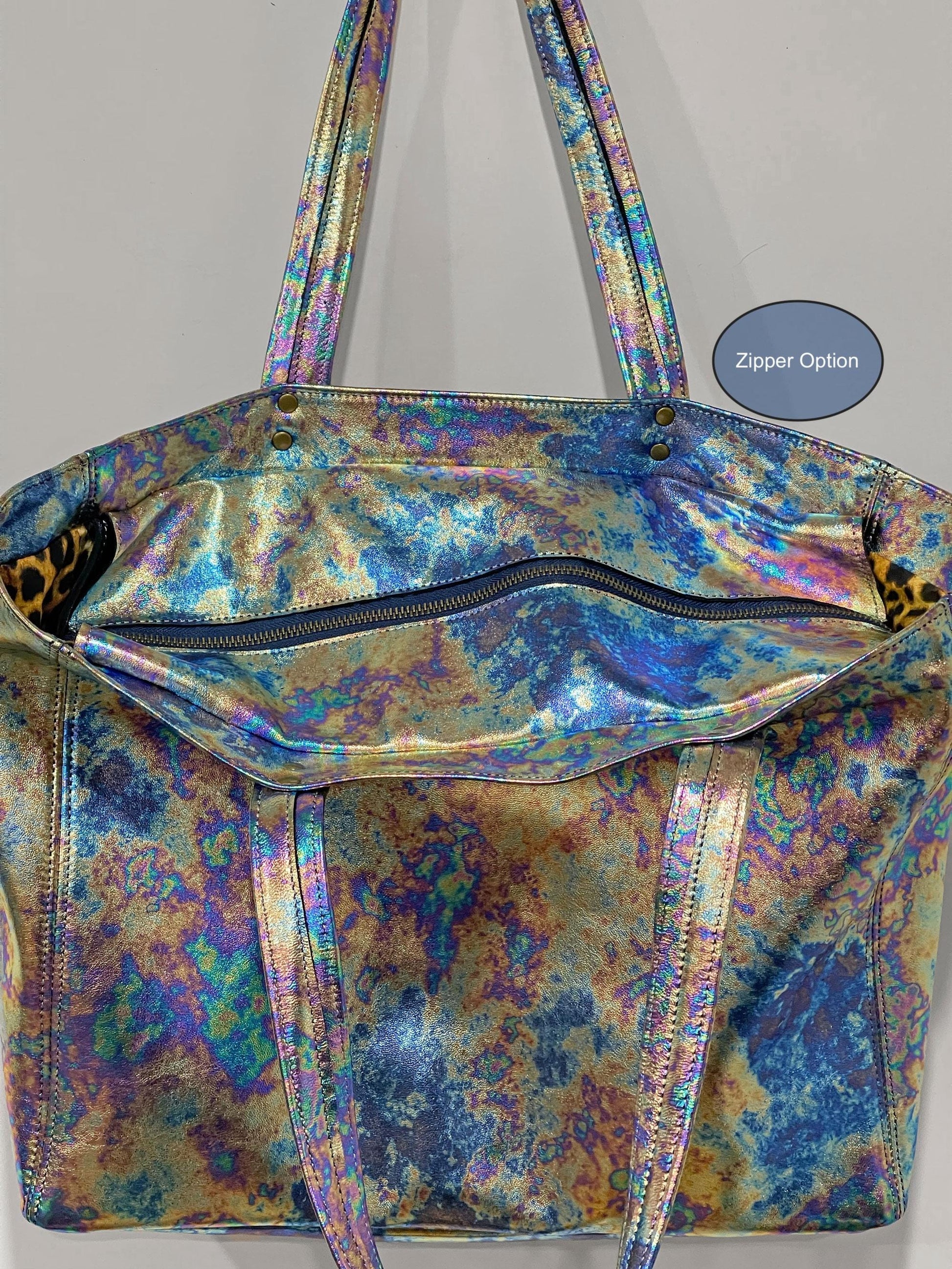 Random Colourful pattern tote bag showing open with secure zipper closure on a gray background