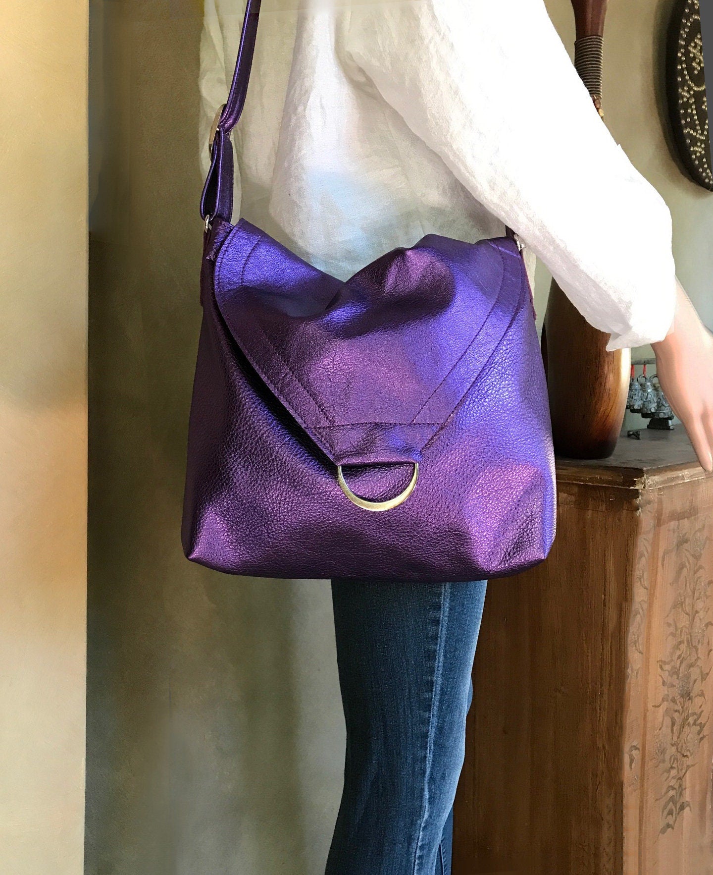 Person wearing a purple handbag with a neutral background