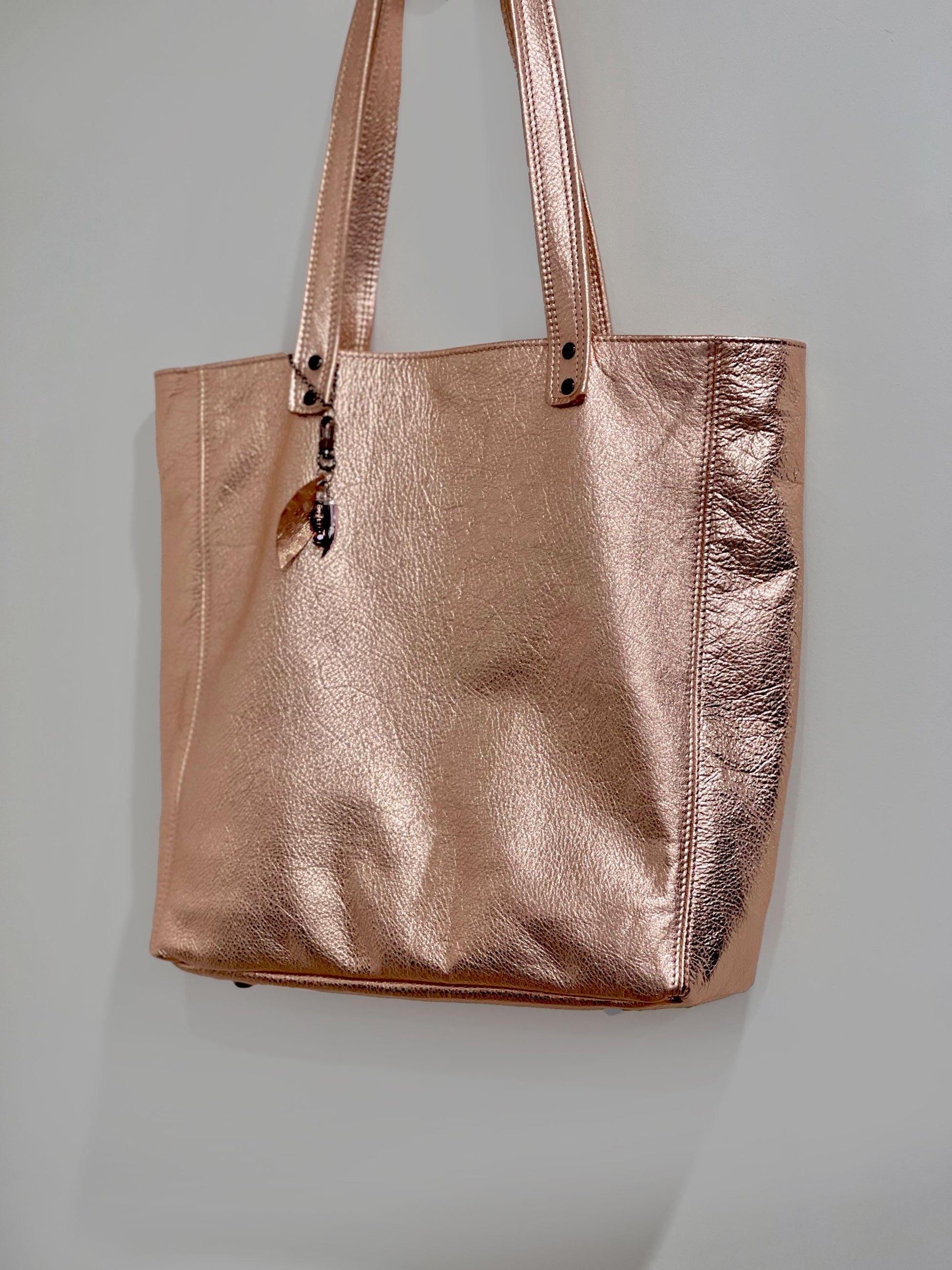 Rose gold tote bag on a light gray background