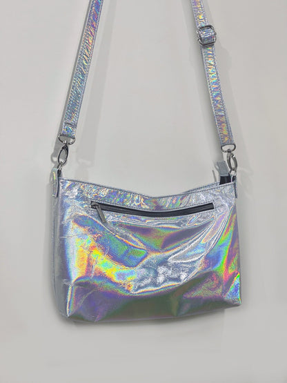 Holographic crossbody bag on a light gray background