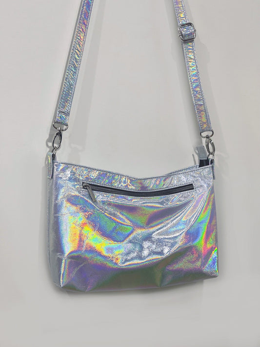 Holographic crossbody bag on a light gray background