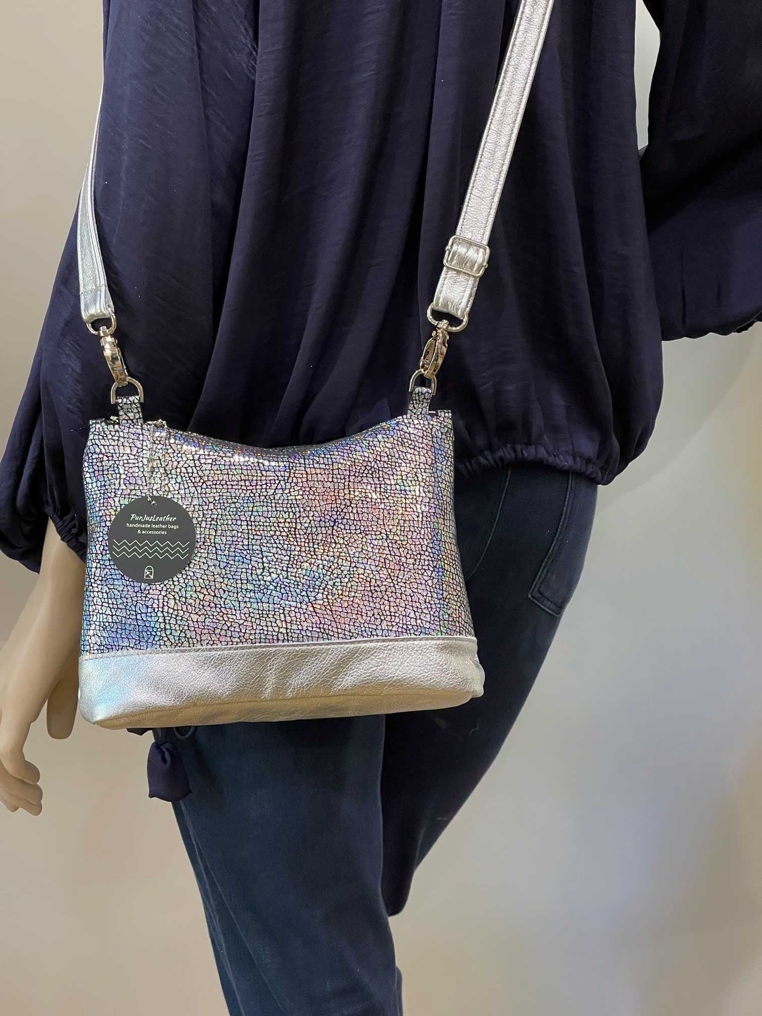 Person wearing a sparkly handbag with a neutral background