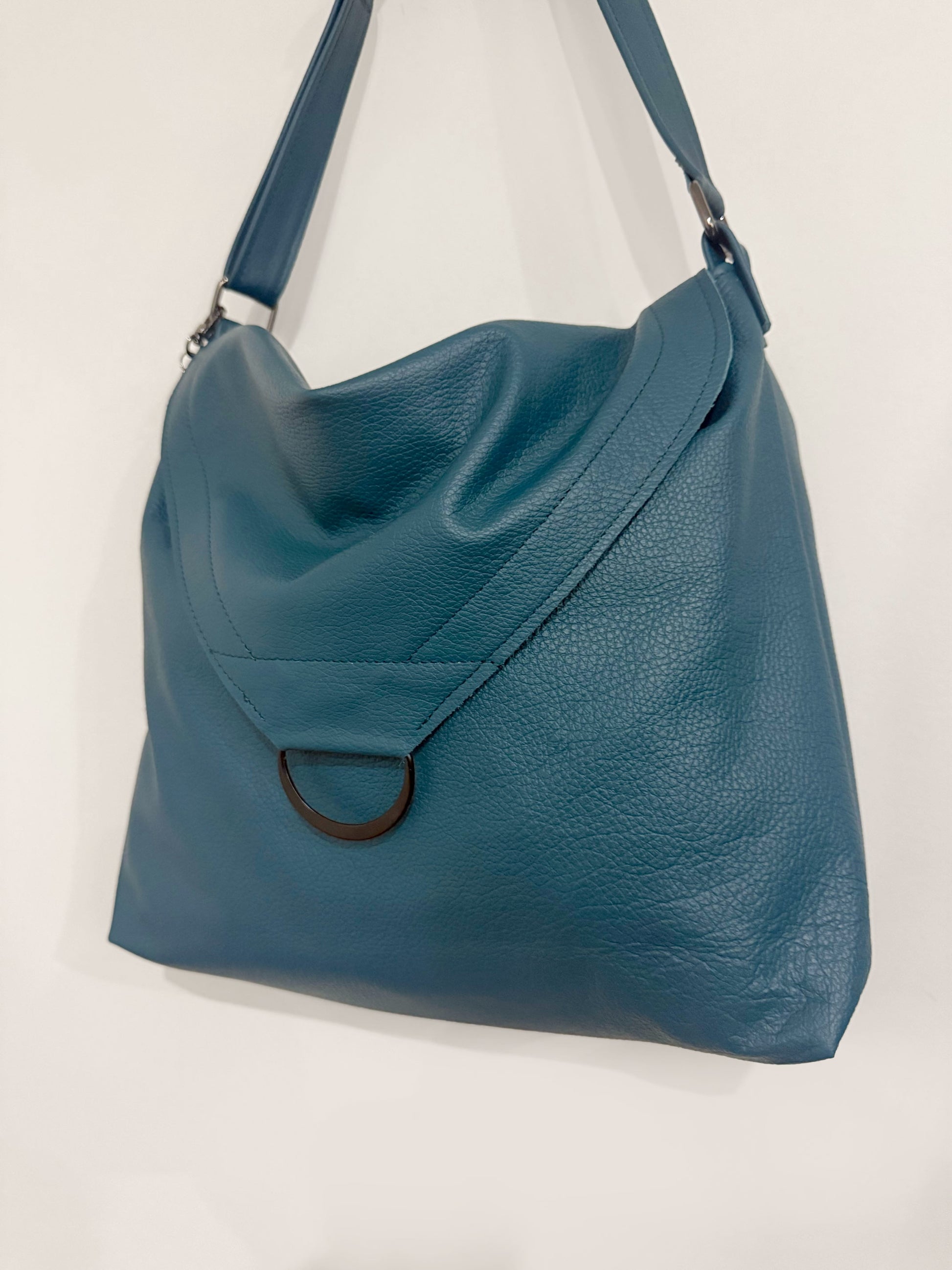 Soft pebble grain teal leather handbag with flap close