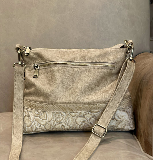 Grainy Beige leather handbag with floral pattern tooled onto the bottom half of the bag. with removable strap